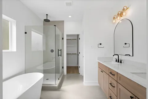 a bathroom with a sink mirror toilet and bathtub