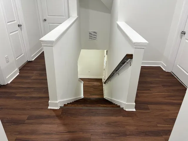 a view of entryway and hall with wooden floor