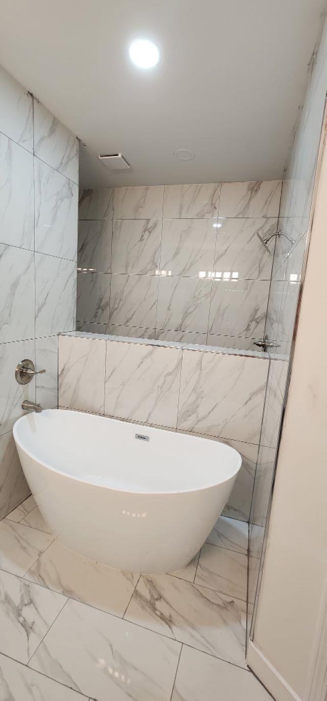 4566 Independent Road Bartlett, TN 38002 - Photo 9 of 24 a white tub sitting in a bathroom