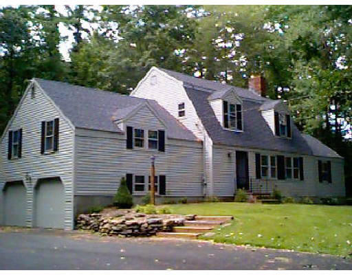 148 Spofford Road Boxford, MA 01921 - Photo 2 of 2 a front view of a house with a yard and garage