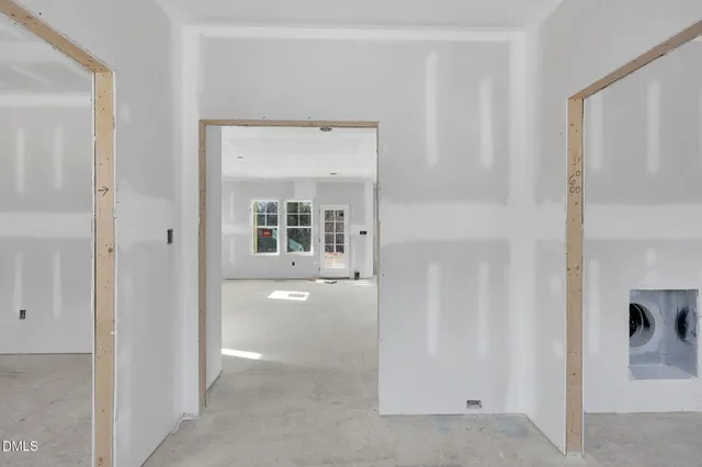a view of a hallway with wooden floor and closet