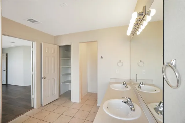 a bathroom with a granite countertop sink a toilet and a mirror