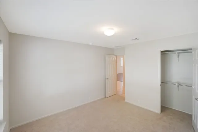 a view of an empty room and a window