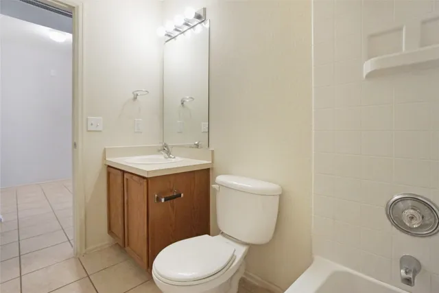a bathroom with a double vanity sink mirror and bathtub