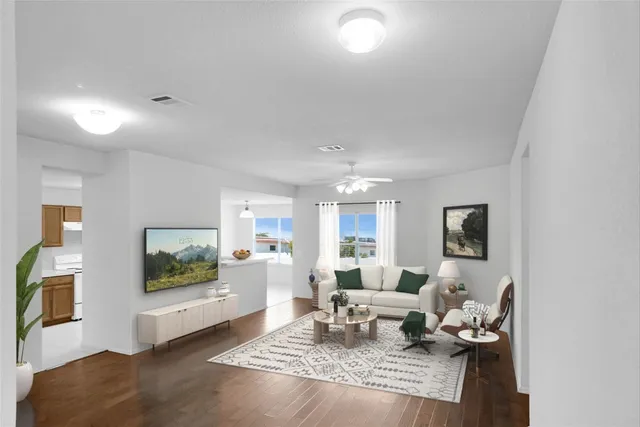 a living room with furniture and a flat screen tv
