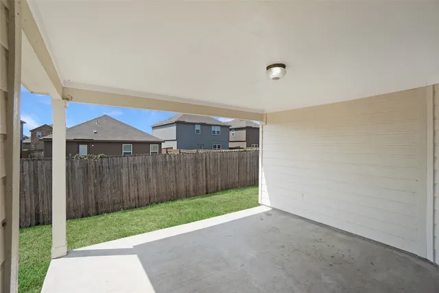 a view of a house with a yard and a large tree