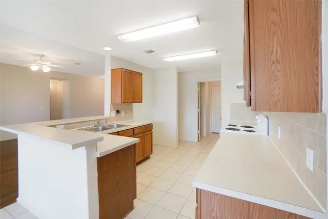 a large kitchen with kitchen island a sink stainless steel appliances and cabinets