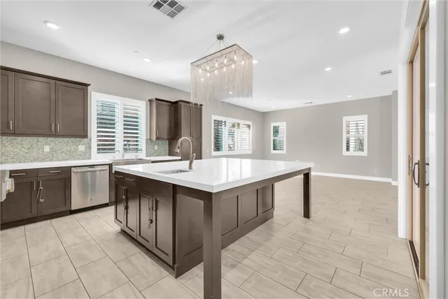 a large kitchen with kitchen island a sink stainless steel appliances and cabinets