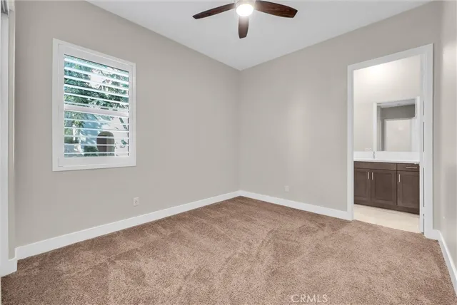 a bathroom with a granite countertop sink toilet a mirror and shower