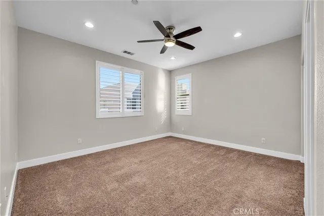 a bathroom with a granite countertop sink toilet a large mirror a shower and a window