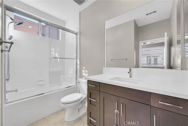 a view of a livingroom with a ceiling fan and window