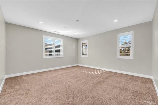 a spacious bathroom with a granite countertop sink two mirror and a