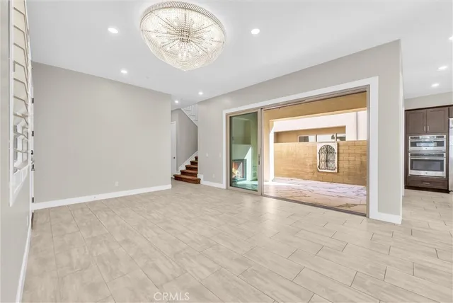 a large kitchen with stainless steel appliances lots of counter space and a sink