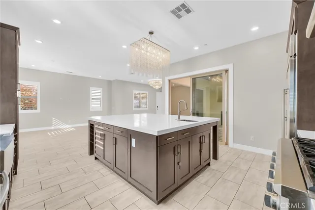 a kitchen with a stove sink and cabinets