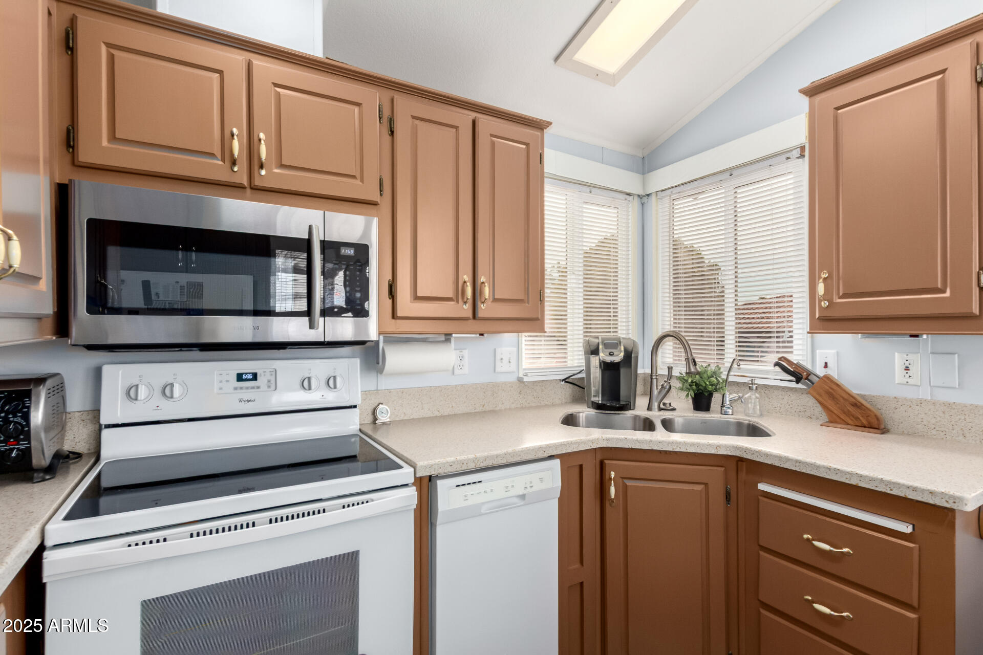 111 South Greenfield Road, Unit 480 Mesa, AZ 85206 - Photo 11 of 29 a kitchen with stainless steel appliances a stove microwave and cabinets