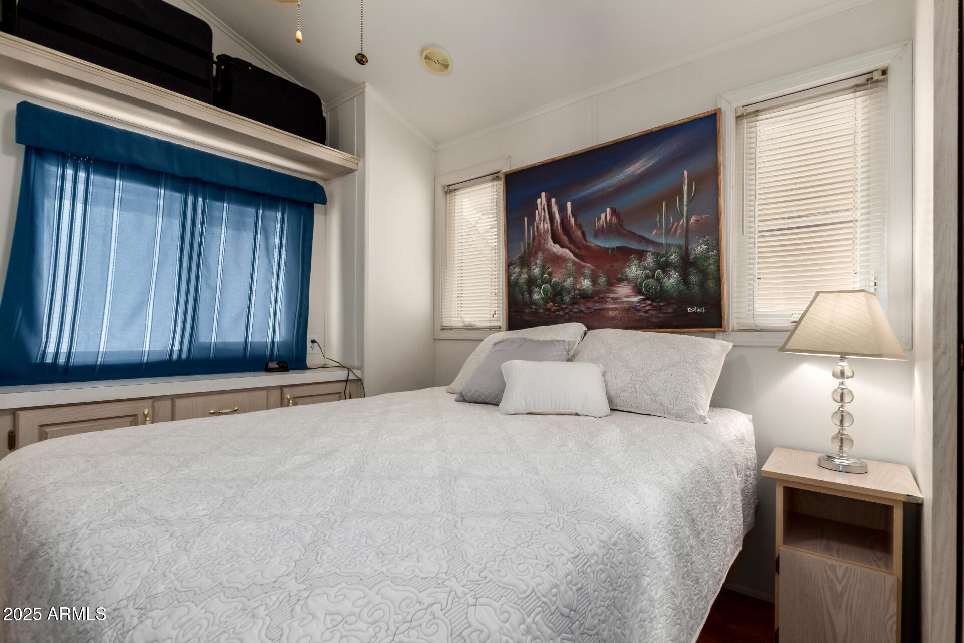 111 South Greenfield Road, Unit 480 Mesa, AZ 85206 - Photo 15 of 29 a bedroom with a bed and a painting on the wall