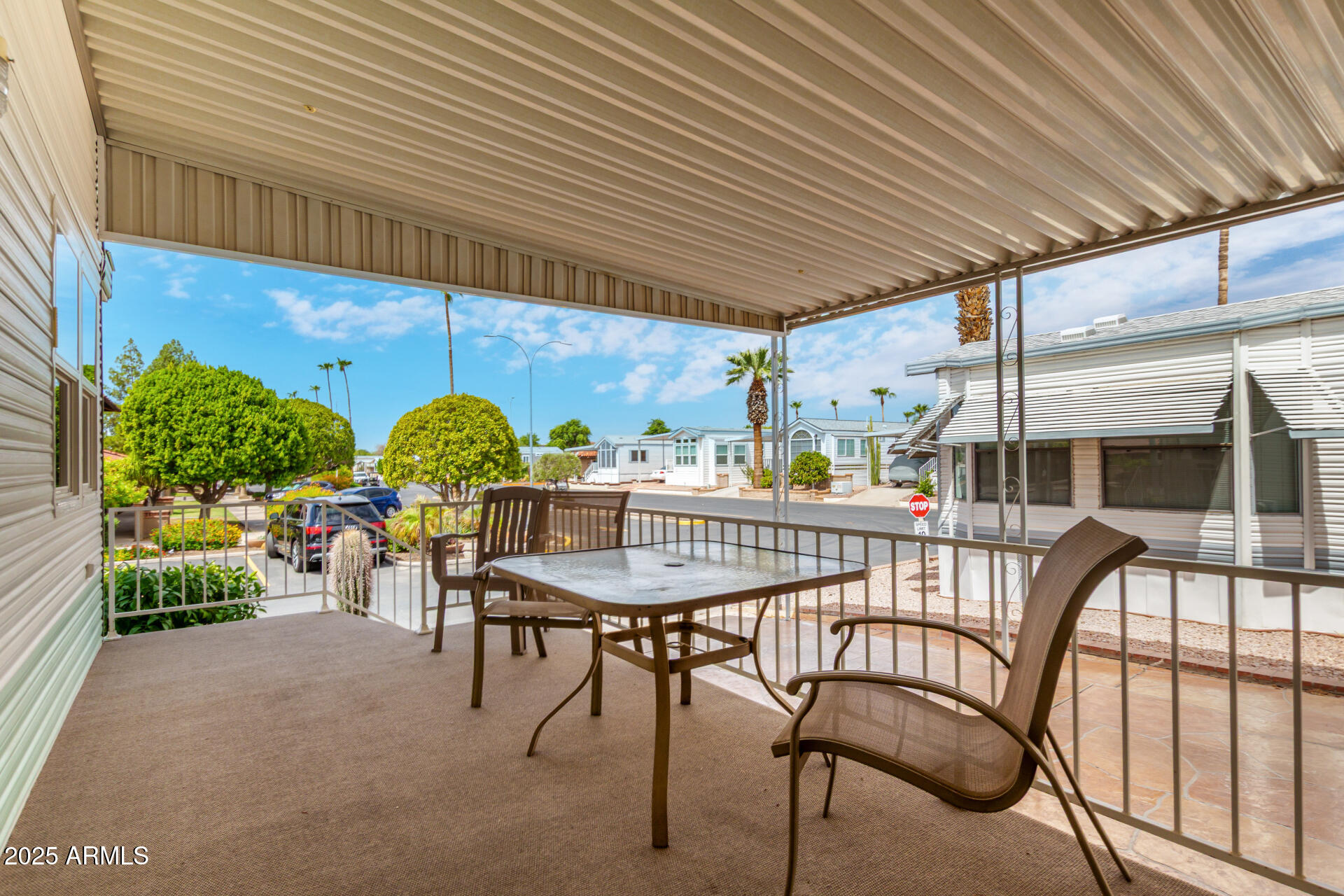111 South Greenfield Road, Unit 480 Mesa, AZ 85206 - Photo 4 of 29 a view of a patio with a table and chairs and potted plants