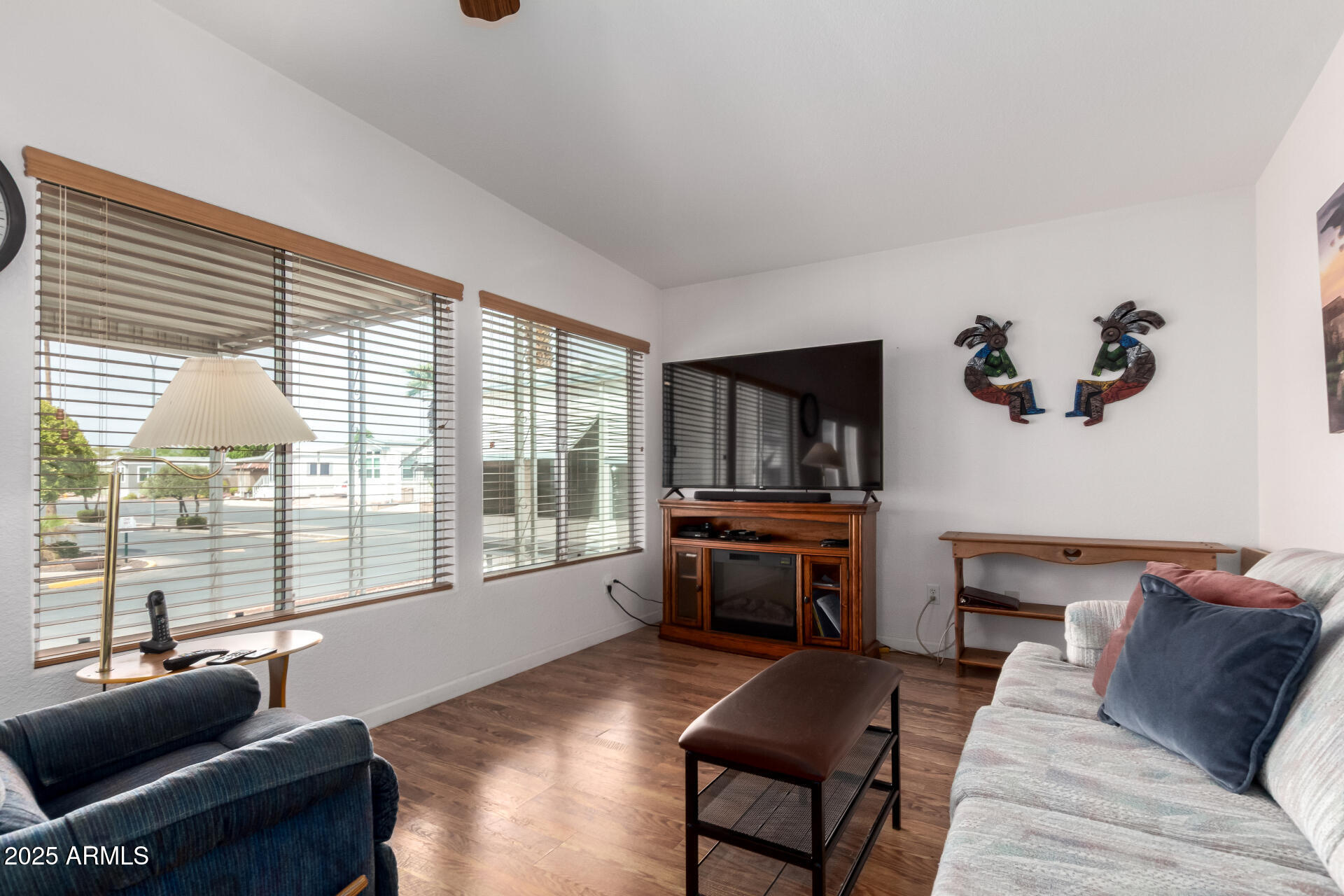 111 South Greenfield Road, Unit 480 Mesa, AZ 85206 - Photo 5 of 29 a living room with furniture and a floor to ceiling window
