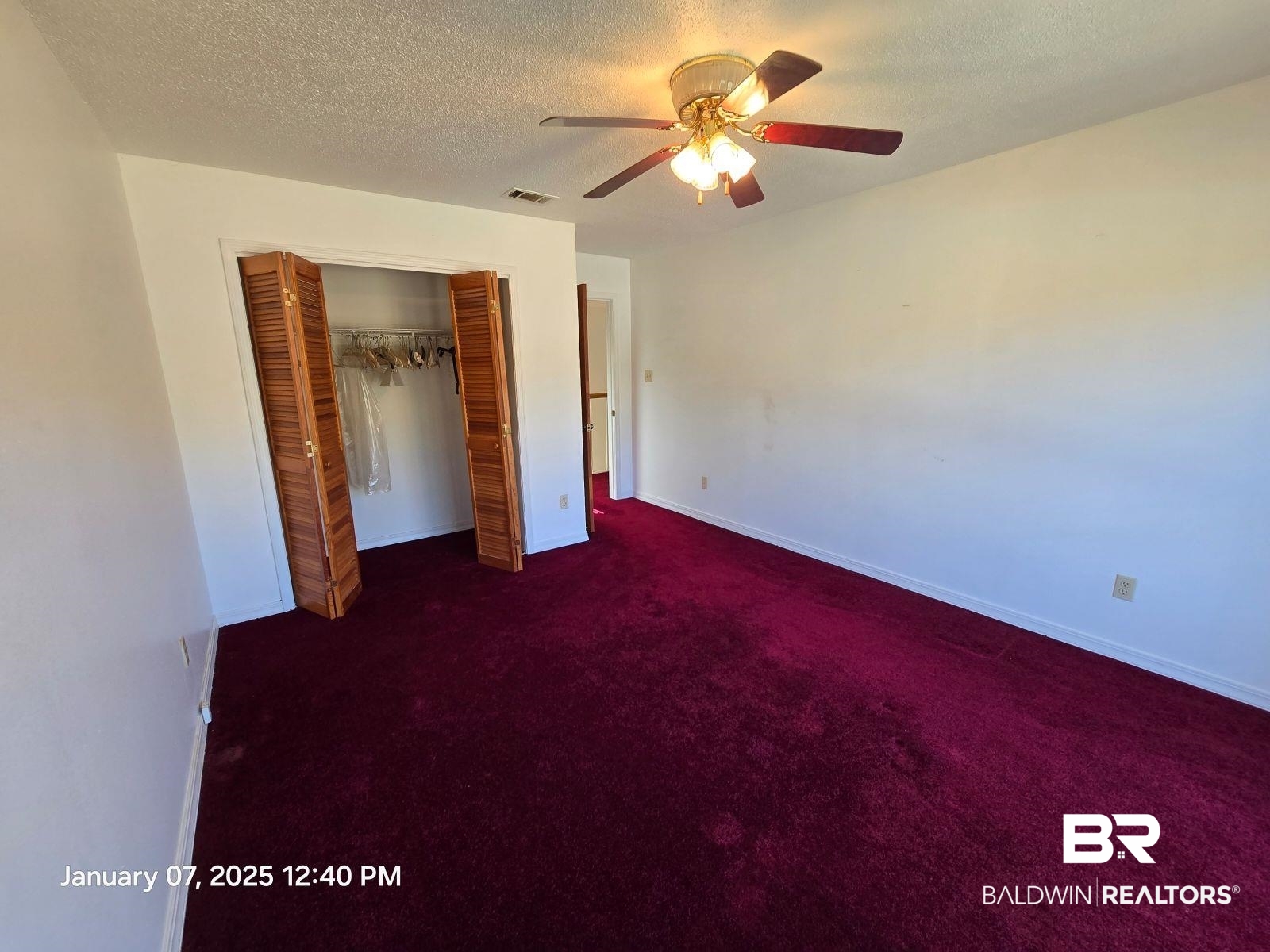 154 Byrd Road Monroeville, AL 36460 - Photo 17 of 26 Unfurnished bedroom with dark colored carpet, a textured ceiling, ceiling fan, and a closet