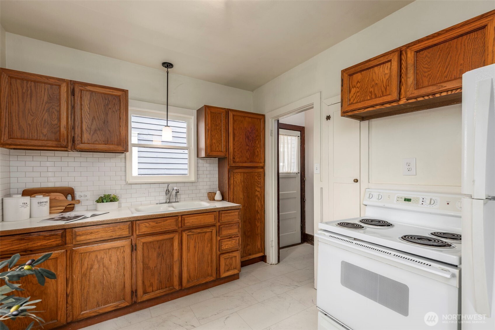 1815 29th Avenue South Seattle, WA 98144 - Photo 11 of 25 a kitchen with stainless steel appliances granite countertop a sink stove and refrigerator