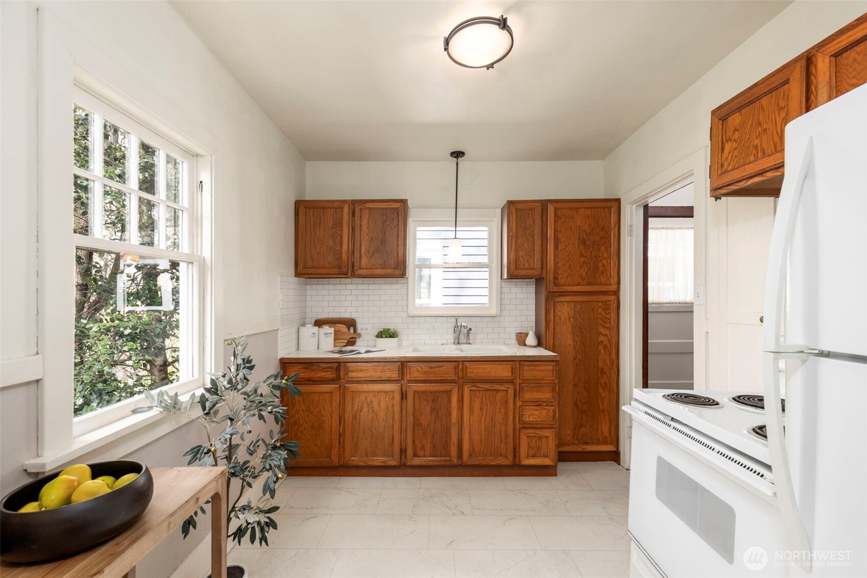 1815 29th Avenue South Seattle, WA 98144 - Photo 10 of 25 a kitchen with stainless steel appliances a sink cabinets and wooden floor