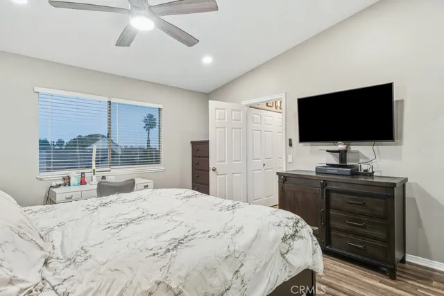 a bedroom with a bed and a flat screen tv