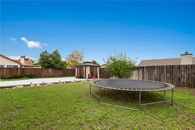 a view of a wooden dinning table and chairs in the patio