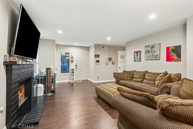 a living room with fireplace furniture and a flat screen tv