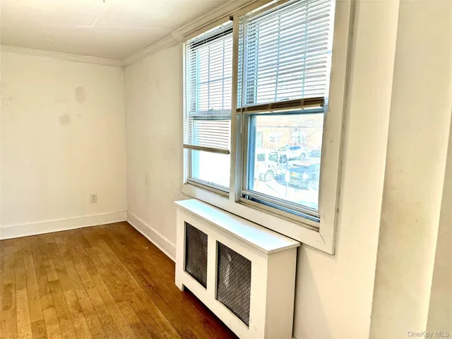a view of a kitchen with wooden floor and a window