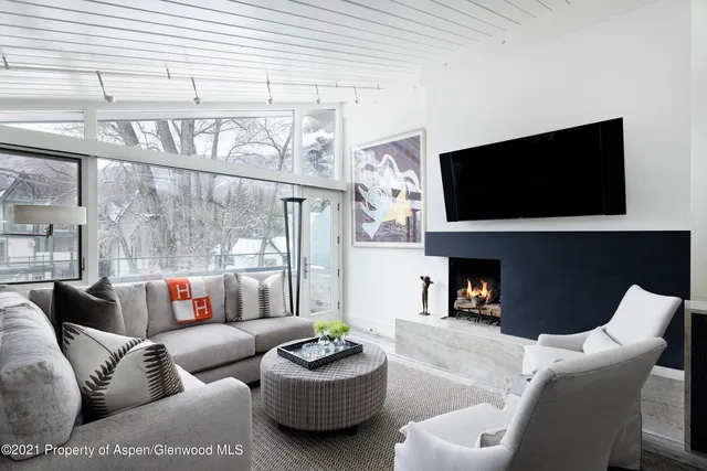 a living room with fireplace furniture and a flat screen tv