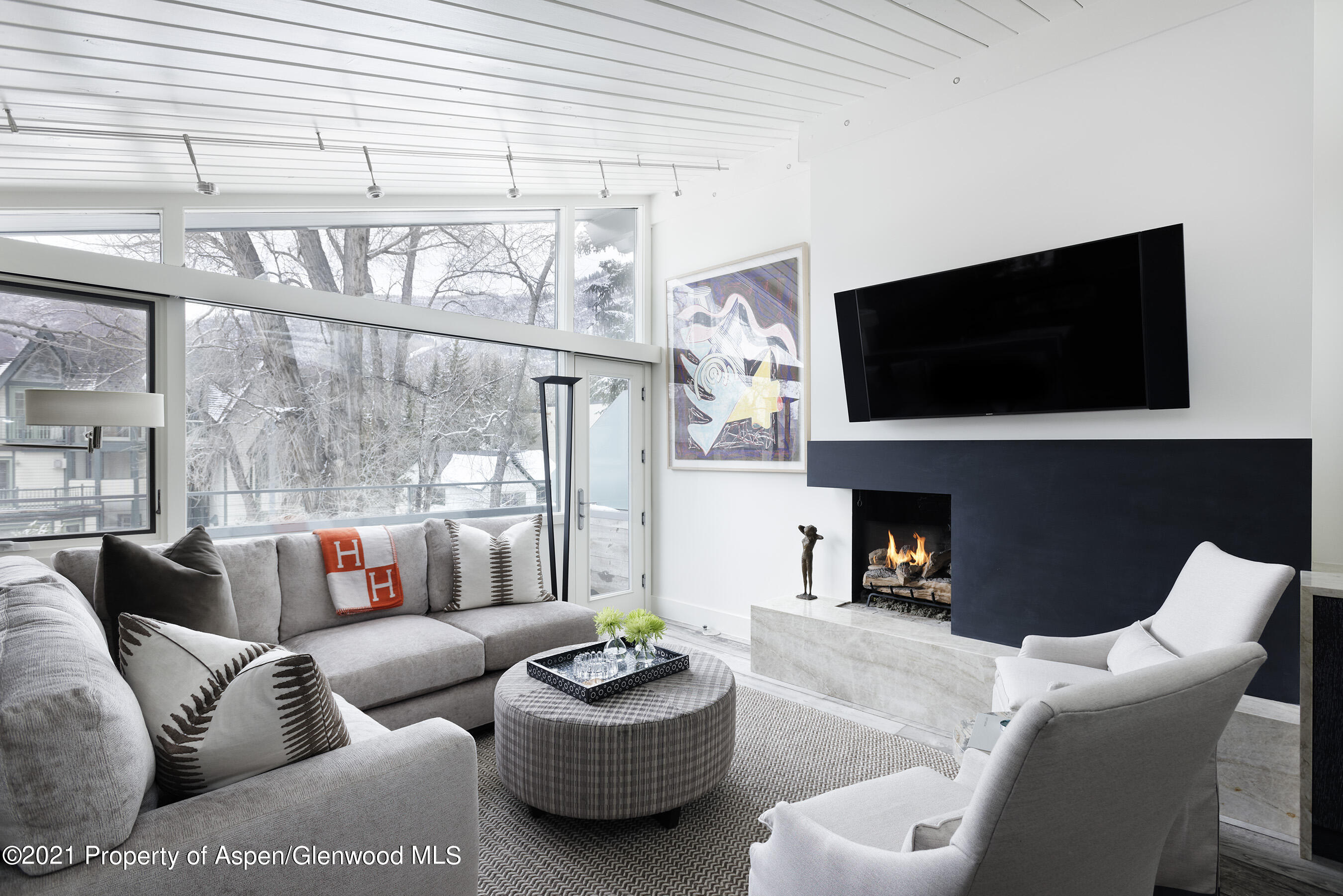 1001 East Cooper Avenue, Unit 2 Aspen, CO 81611 - Photo 1 of 17 a living room with fireplace furniture and a flat screen tv