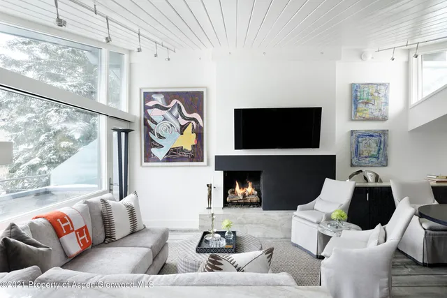 a living room with furniture fireplace and a flat screen tv