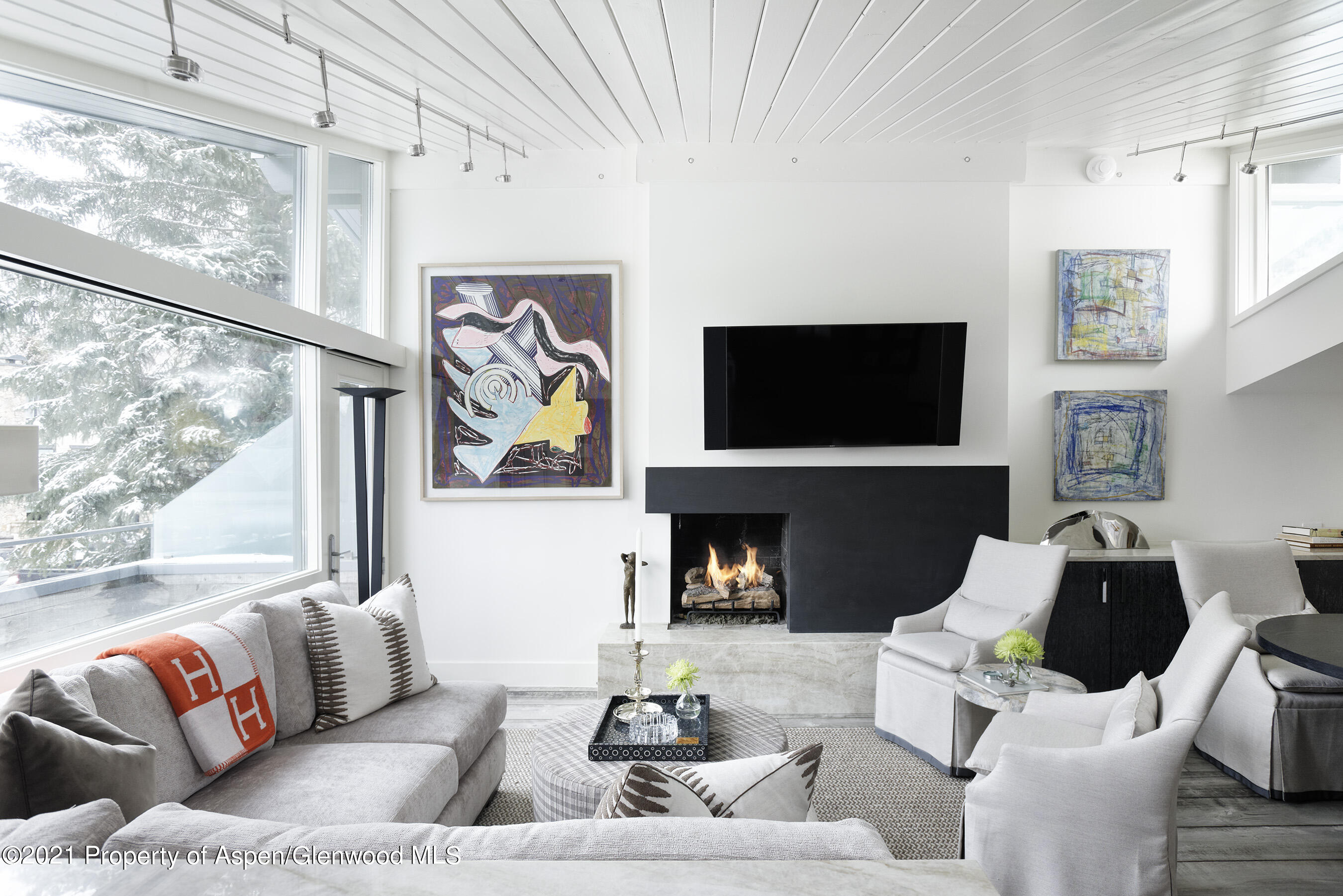 1001 East Cooper Avenue, Unit 2 Aspen, CO 81611 - Photo 2 of 17 a living room with furniture fireplace and a flat screen tv
