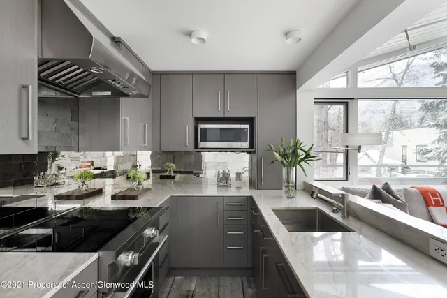 a kitchen with a sink a counter and cabinets