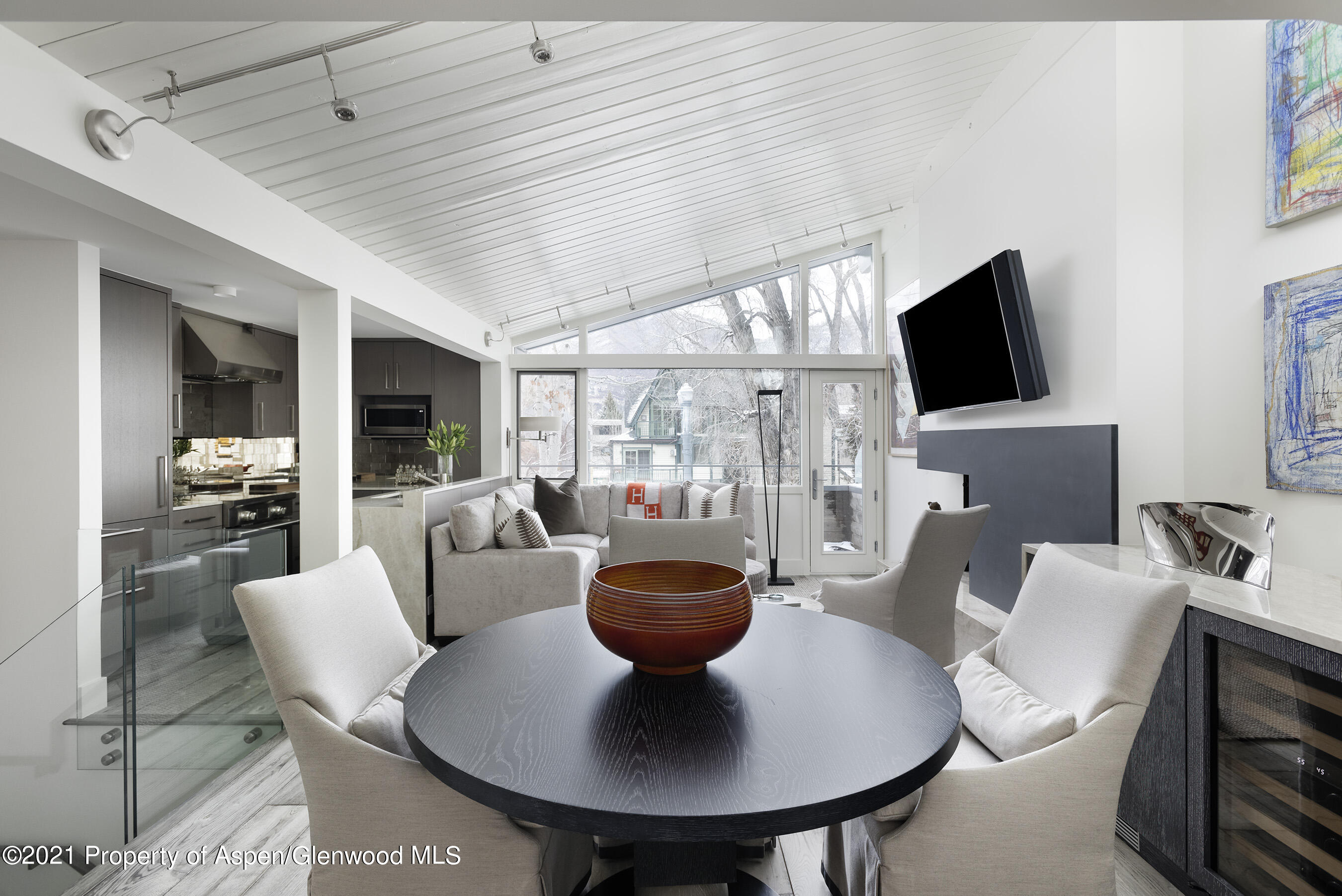 1001 East Cooper Avenue, Unit 2 Aspen, CO 81611 - Photo 4 of 17 a living room with furniture a flat screen tv and a large window