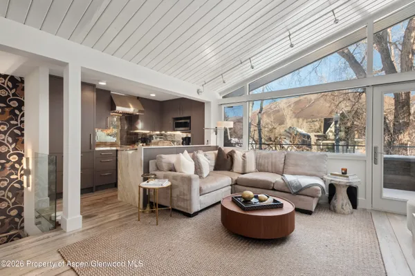 a living room with fireplace furniture and a flat screen tv