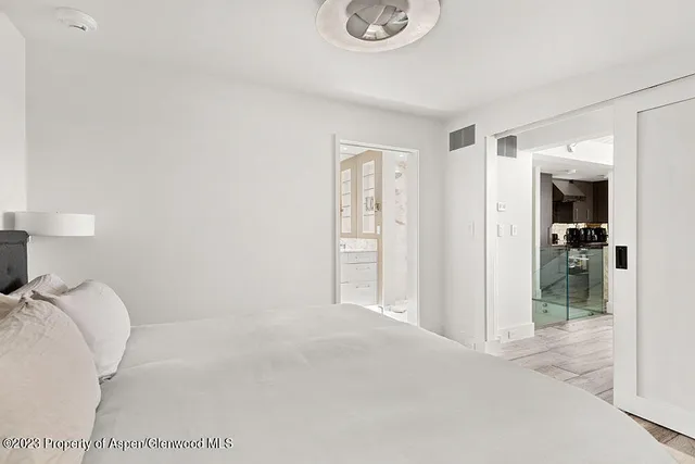 a view of a bedroom with cabinet and closet