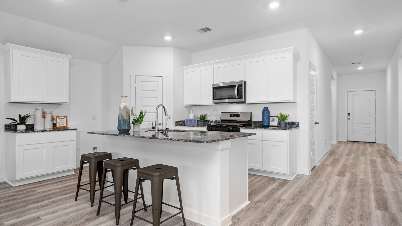 5630 Canvasback Orange, TX 77632 - Photo 4 of 31 a kitchen with white cabinets and stainless steel appliances