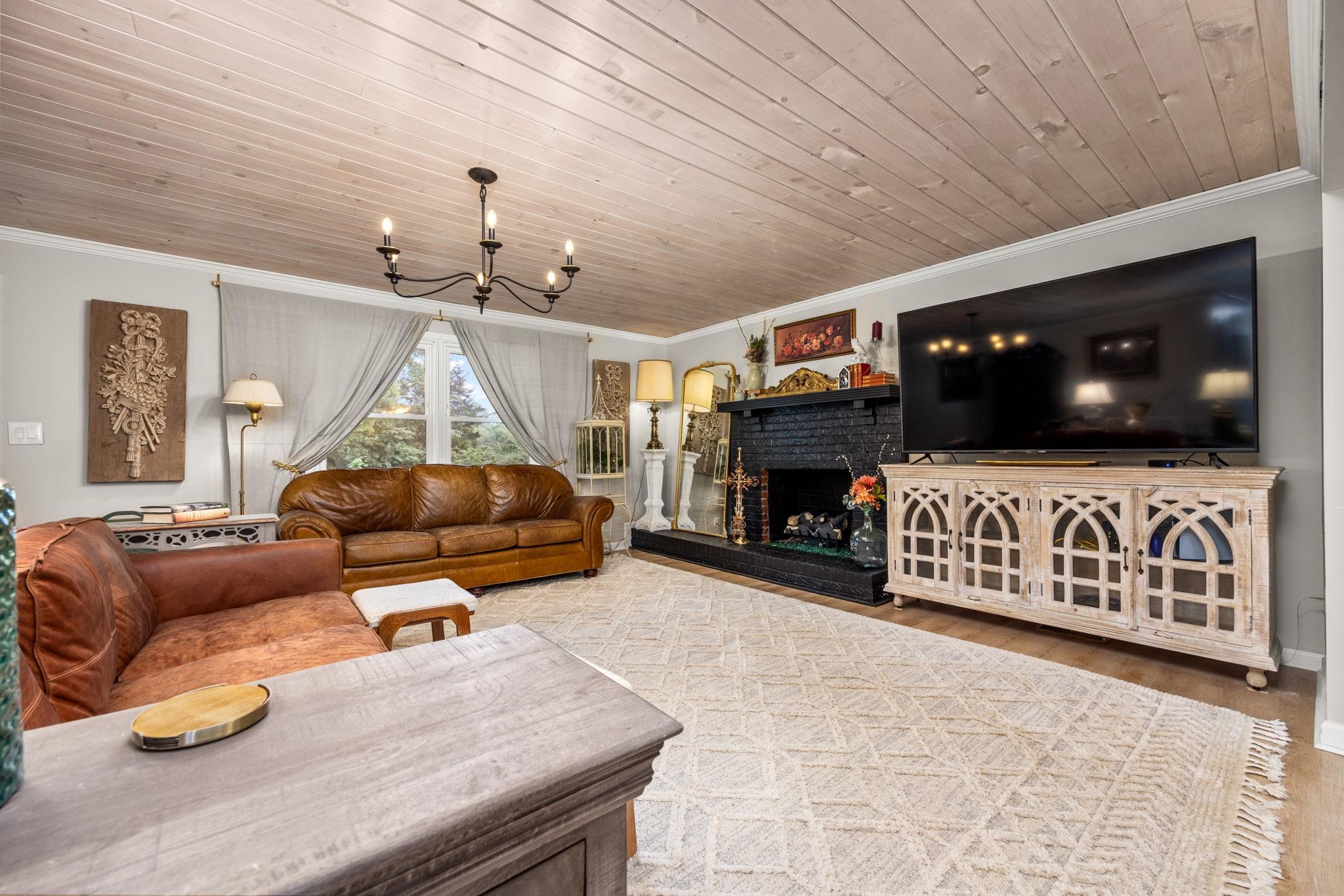 2219 Hillcrest Road Corinth, MS 38834 - Photo 7 of 40 Living room featuring wood-type flooring, a fireplace, crown molding, and wood ceiling