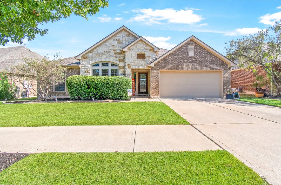 947 Madrone Drive Georgetown, TX 78628 - Photo 1 of 32 a front view of a house with a yard and garage