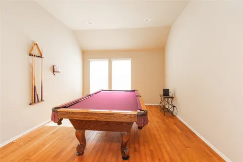 a room with a bed and a wooden floor