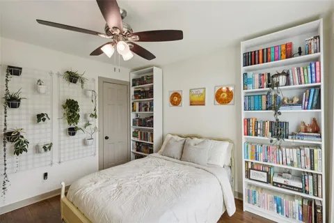 a bedroom with a bed cabinets and book shelf