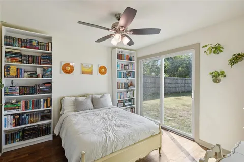 a bedroom with a bed and a book shelf