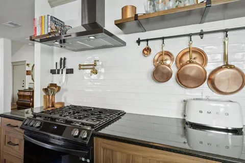 a stove top oven sitting inside of a kitchen