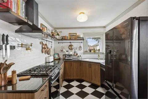 a kitchen with a sink a stove and cabinets