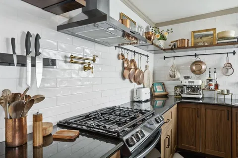 a kitchen with lots of counter top space and stove