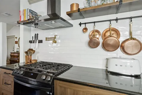 a stove top oven sitting inside of a kitchen