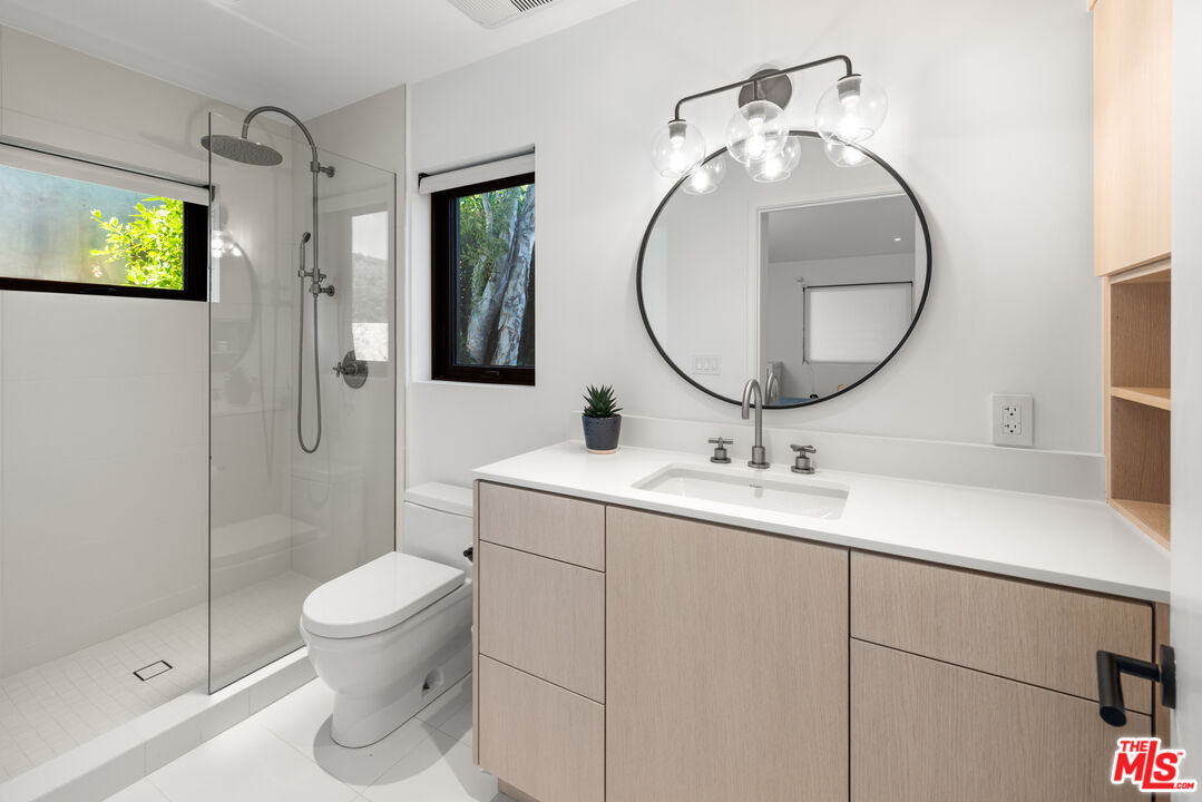 24604 Malibu Road Malibu, CA 90265 - Photo 12 of 17 a bathroom with a toilet sink and mirror
