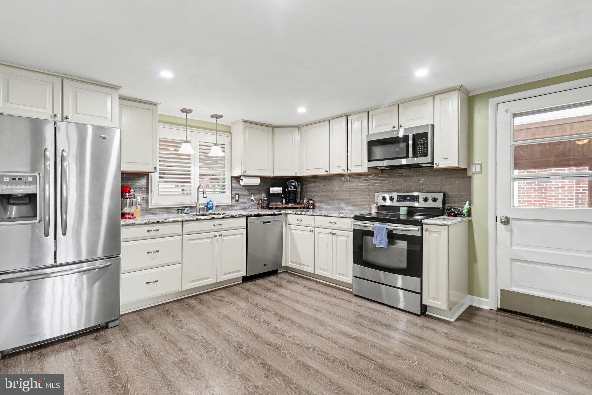 609 North Franklin Street Pottstown, PA 19464 - Photo 12 of 41 a kitchen with granite countertop white cabinets and stainless steel appliances