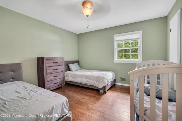 a bedroom with two beds and a chandelier